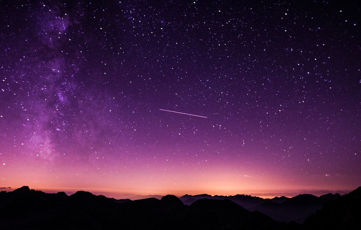 A mystical starlit night sky over the mountains, evoking Vedic and Tantric remedies