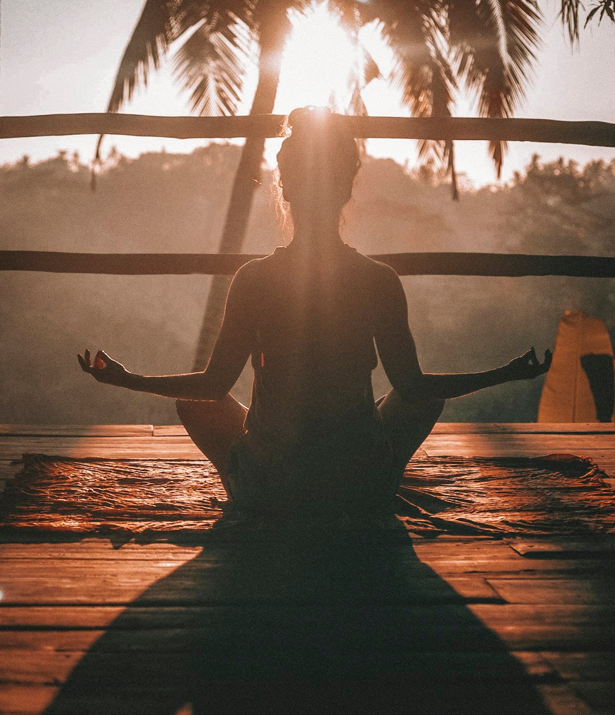 A person meditating at sunrise, embodying Vedic balance and inner peace
